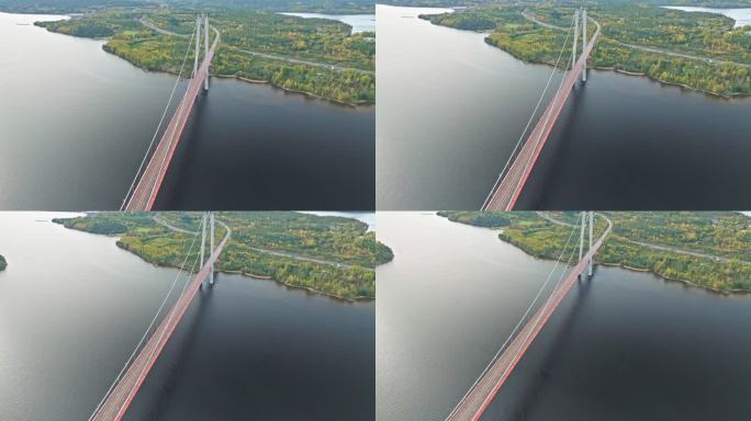 飞越瑞典以秋天森林为背景的Hogakustenbron大桥全景。空中拍摄