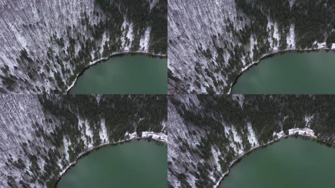 冬季火山口湖的空中无人机视图。在罗马尼亚特兰西瓦尼亚塞克勒兰的斯芬达安娜湖上空飞行
