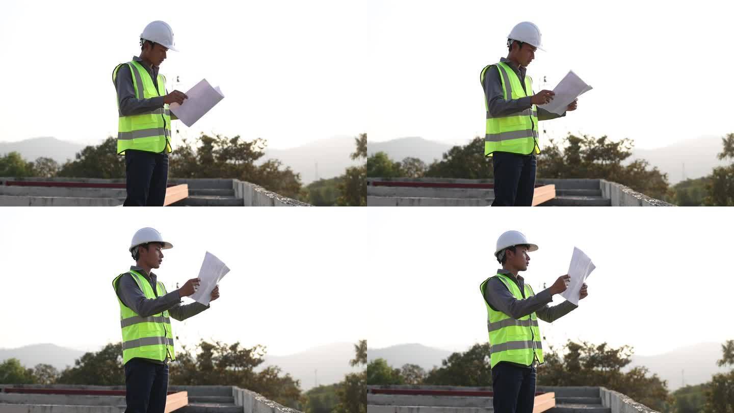 工程师们穿着安全背心和头盔。检查建筑物结构。工程和建筑概念。