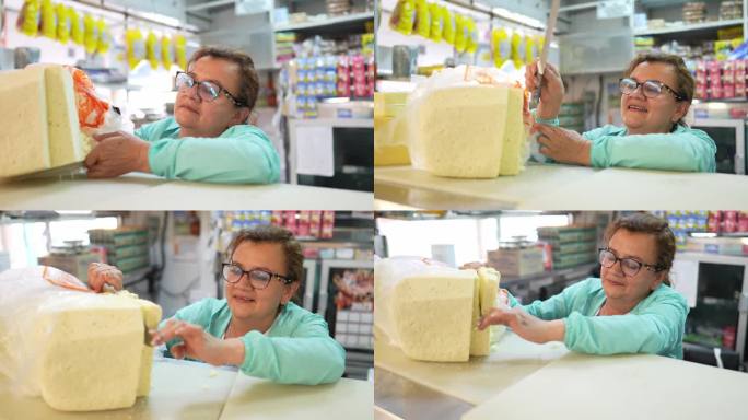成熟的女店员在超市切奶酪