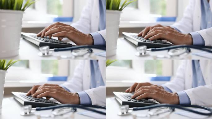 医生在电脑键盘上打字。在诊所工作。在线医疗咨询。滑块拍摄