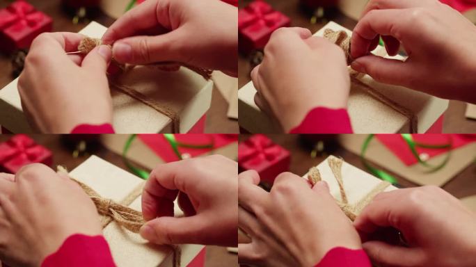 手包装圣诞新年或生日礼盒在木制桌面周围的信件和礼物，俯视图，新年装饰和快乐的节日气氛，2024年，2