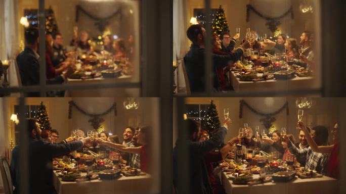 透过雪屋窗户的电影镜头:与父母，孩子和朋友在家里共进圣诞晚餐。多元文化家庭举起香槟酒杯敬酒，庆祝节日