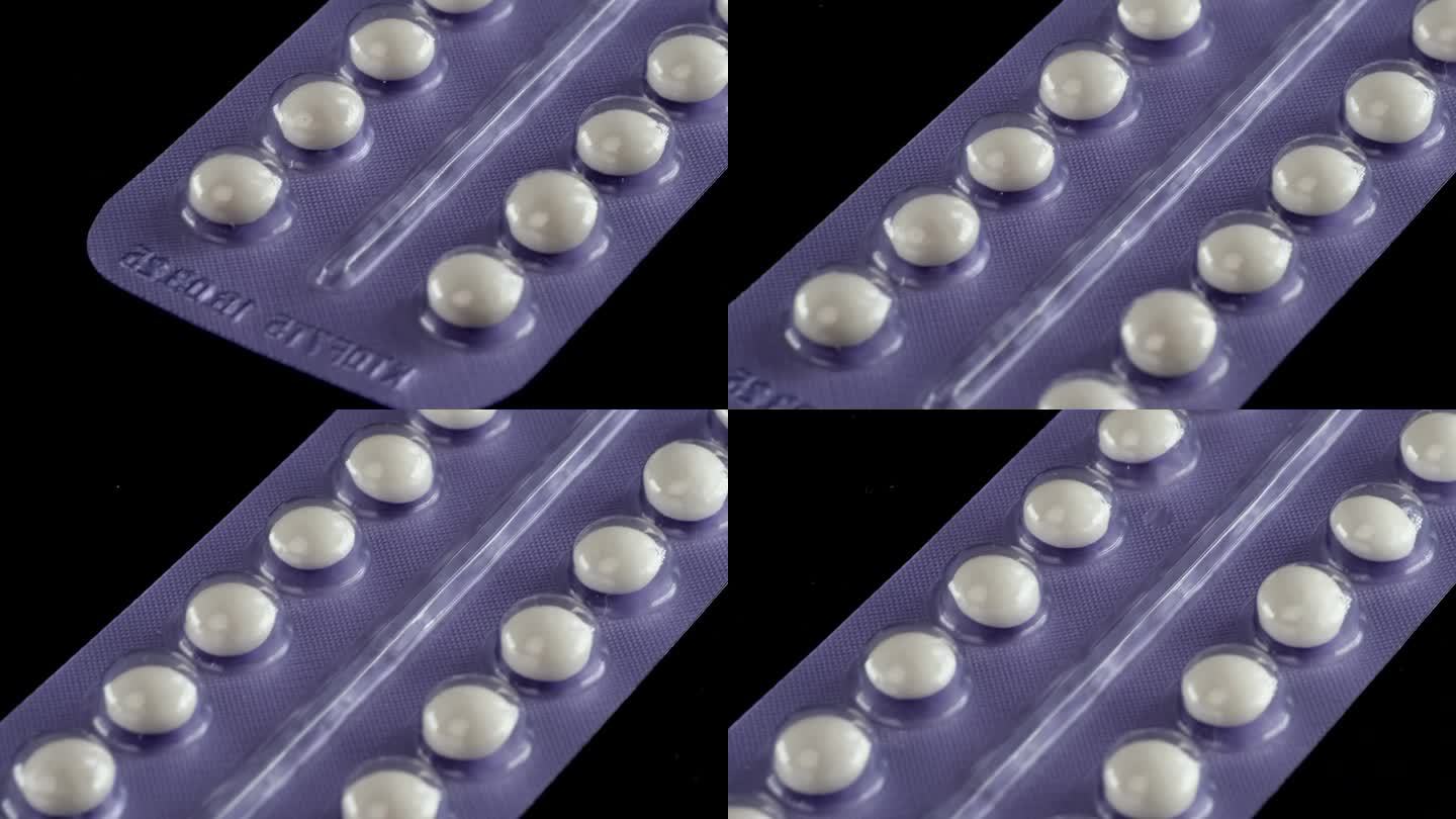 白色避孕药滑块快速跟踪拍摄微距特写。维生素，退烧药和抗抑郁药