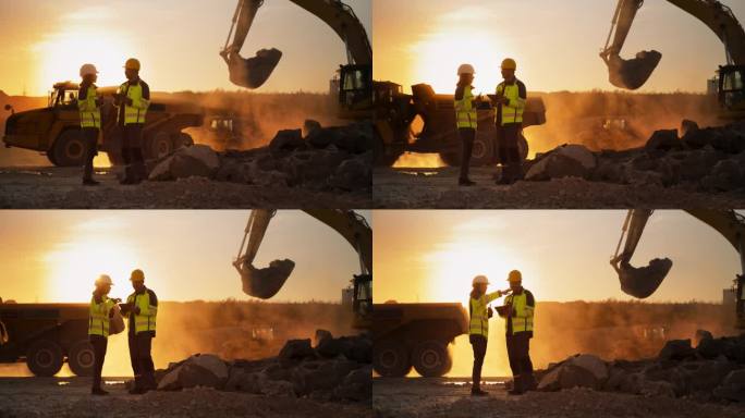 建筑工地的电影黄金时刻镜头:白人男性土木工程师和西班牙裔女性建筑师交谈并使用平板电脑。卡车、挖掘机、