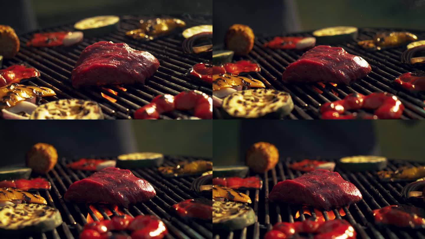 肉牛排被扔在热炭烧烤架与火焰从烤架上升。美味的镜头与牛肉和烤蔬菜。广告风格的超级慢动作镜头