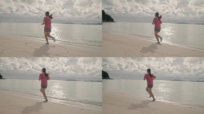 一名亚洲女子在沙滩上跑步