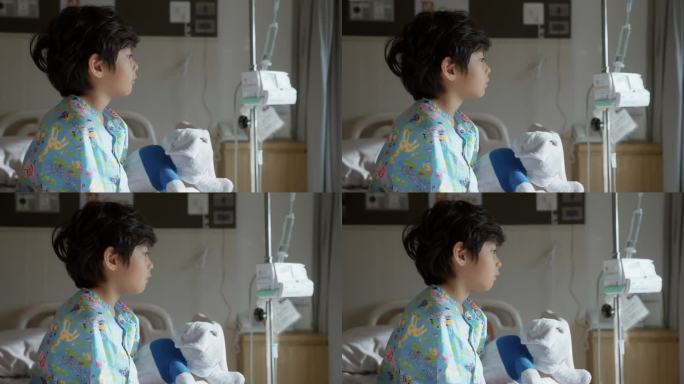 一个患感冒的孩子的侧视图，他很无聊，在医院过周末。望着窗外