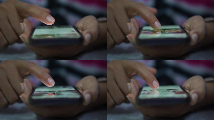 女人在智能手机上触摸手指的特写