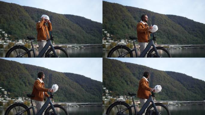 城市通勤者在湖边加速，准备继续他的电动自行车之旅