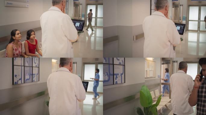 印度医生使用数码平板电脑在医院走廊行走的后视跟踪镜头。资深男性外科医生在手术前检查脑MRI图像的慢动