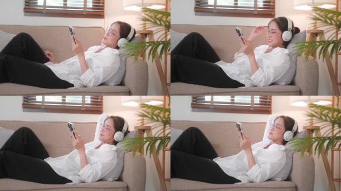 美丽的亚洲女性在家用智能手机放松