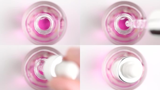 移液器与血清的近距离放入瓶中。微距拍摄的粉红色保湿精华乳液。保健化妆品。