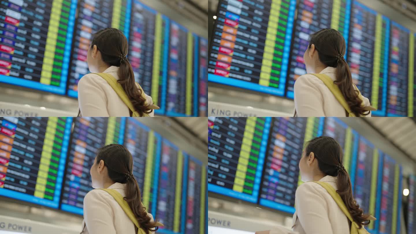 女游客在看机场登机牌