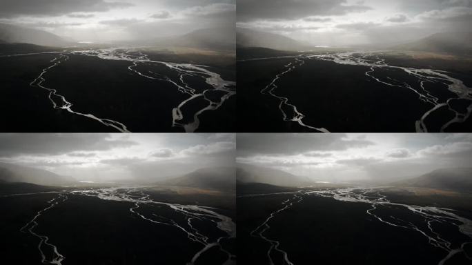电影空中托尔山谷，冰川河流流经黑色火山泛滥平原，thorsmörk戏剧性的喜怒无常的景观冰岛