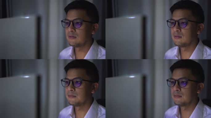 一个商人晚上在电脑前分析数据，情绪紧张。