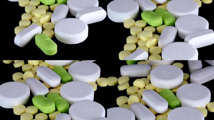 药片和药物白色，绿色和黄色的颜色，维生素，退烧药，避孕药，止痛药和抗生素和营养补充剂。