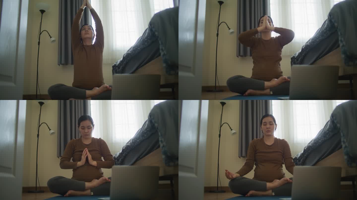 孕妇在家用笔记本电脑在线学习瑜伽