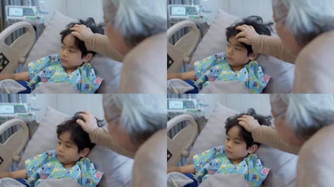 在医院，一位祖母在临睡前抚摸着躺在床上的小男孩的头