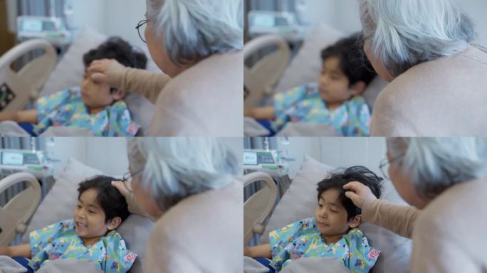 一个生病的小男孩躺在医院的病床上。他的祖母站在他身边，忧心忡忡。