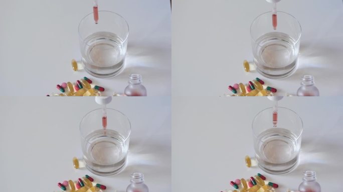 将液体药物从滴管倒入玻璃杯中。医疗保健的概念