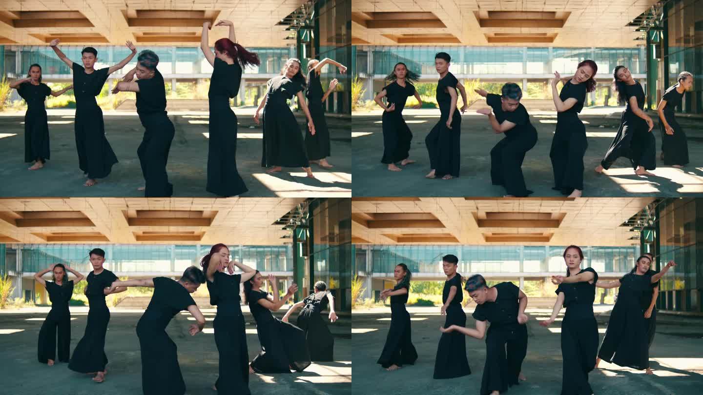 一群亚洲舞者穿着黑色服装，身体轻盈地跳舞