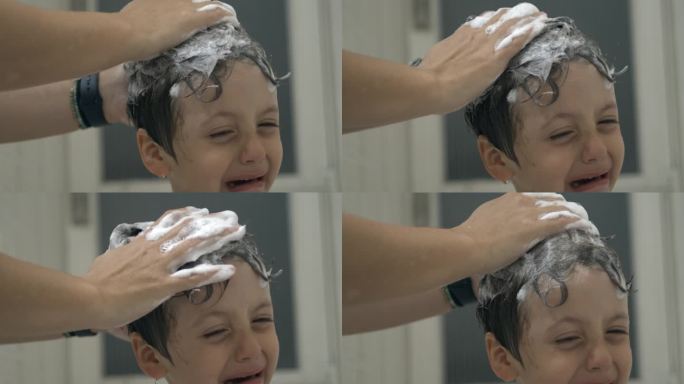 当妈妈用洗发水给孩子洗头时，孩子在哭泣，小男孩在洗澡时的不愉快情绪，800帧/秒的超级慢动作