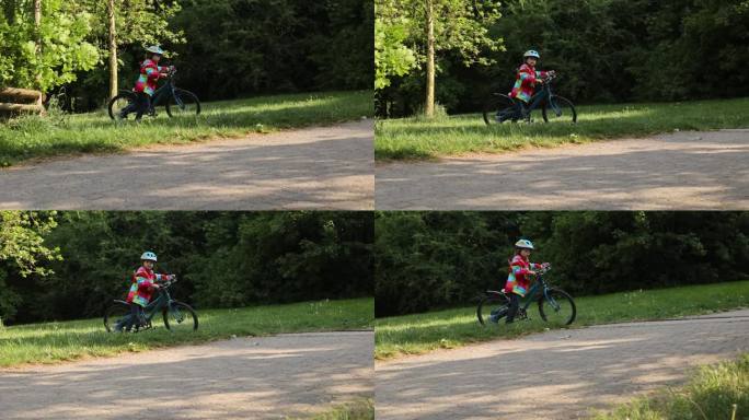 快乐的小男孩，在美好的日子里骑着自行车在公园里玩耍。活跃的孩子