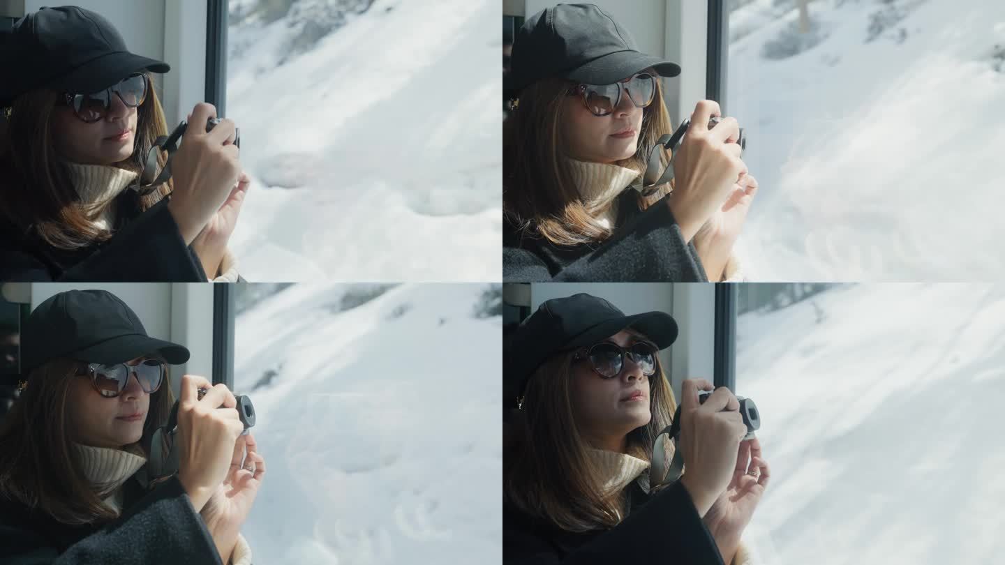 一位亚洲女摄影师在瑞士山区乘火车旅行时，正在拍摄美丽的山景。