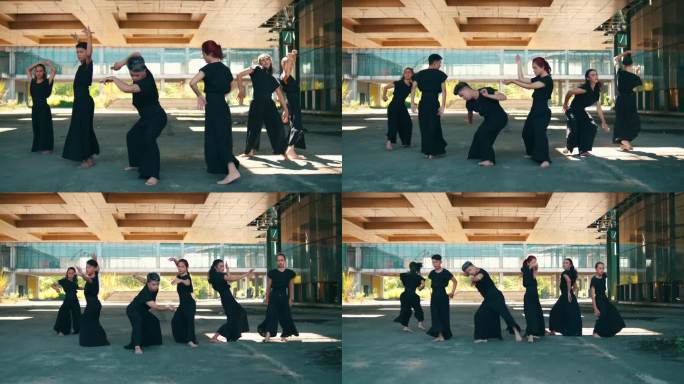 一群亚洲舞者穿着黑色服装，身体轻盈地跳舞