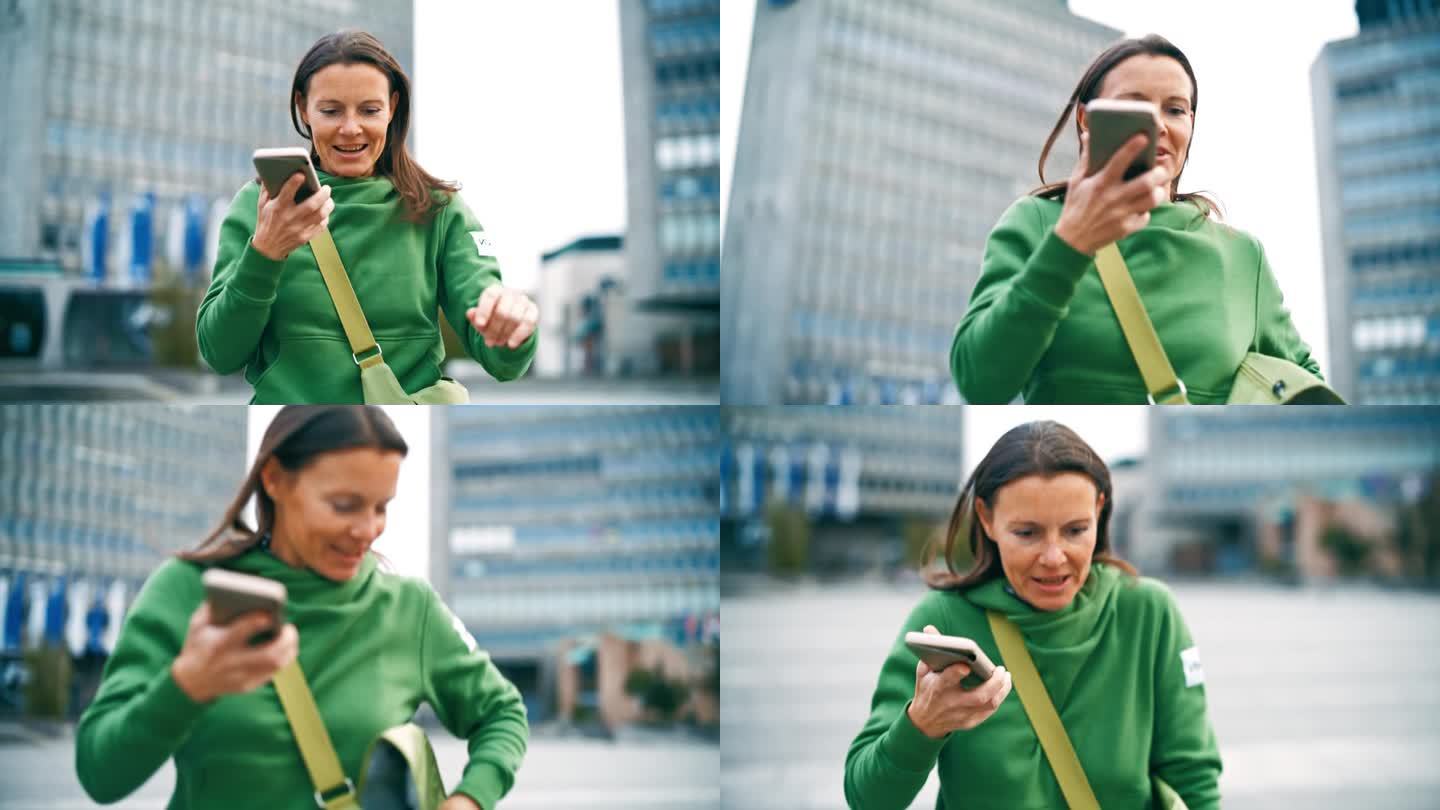 一个拿着智能手机的女人用扬声器打电话，走在城市里
