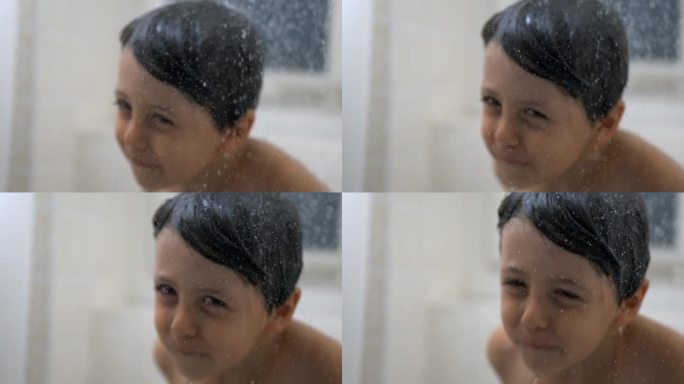 水滴缓慢流动，背景是模糊的孩子，小男孩在洗澡时洗澡的梦幻场景