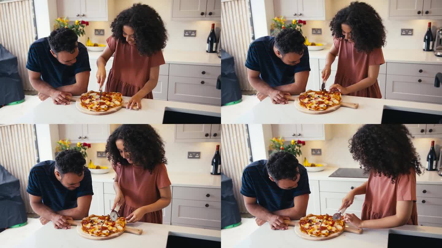 一对夫妇带着患有唐氏综合症的男人和在厨房切自制披萨的女人在家里