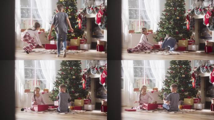 快乐的小弟弟和小妹妹在节日早晨醒来，从圣诞树下收到新玩具的慢镜头。可爱的孩子们迫不及待地去拿礼物