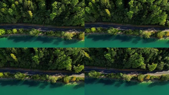 航拍片段捕捉到一条小路，左边是森林，右边是河岸