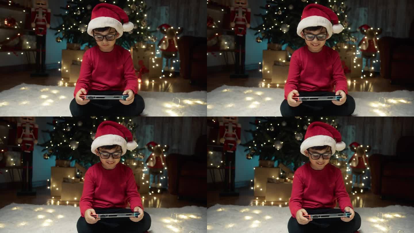孩子在圣诞树下玩电子游戏
