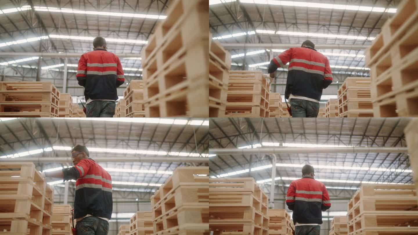 熟练的非洲工人在木棚检查木材库存。