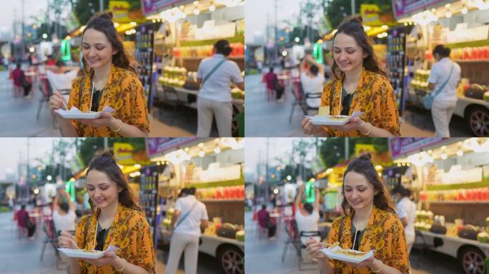 度假期间，一名女子在曼谷夜市吃泰国煎饼(roti)