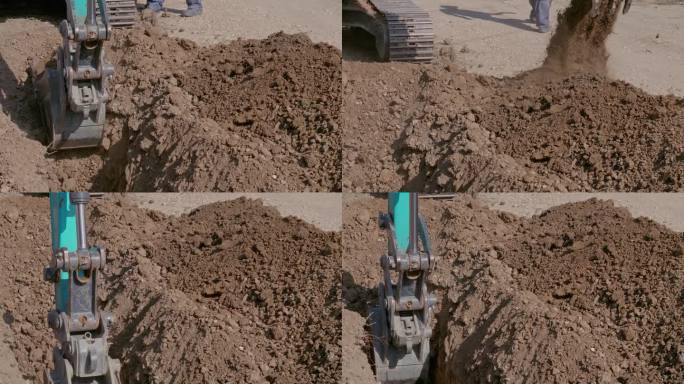 一辆拖拉机在地上挖了一条沟，把泥土倾倒在附近。建筑工程及通讯