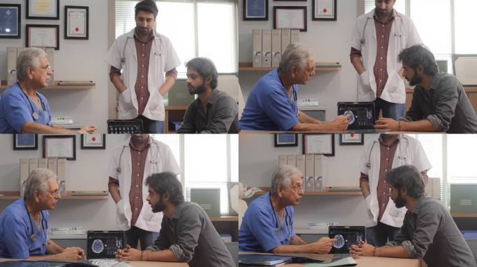 印度男病人在医院预约医生的画像。专业神经科医生使用核磁共振扫描图像和数字平板电脑给病人诊断和建议