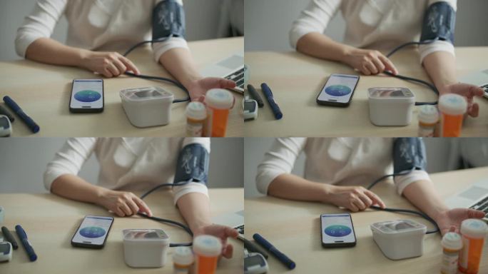 女人正在家里检查血压应用，跟踪镜头