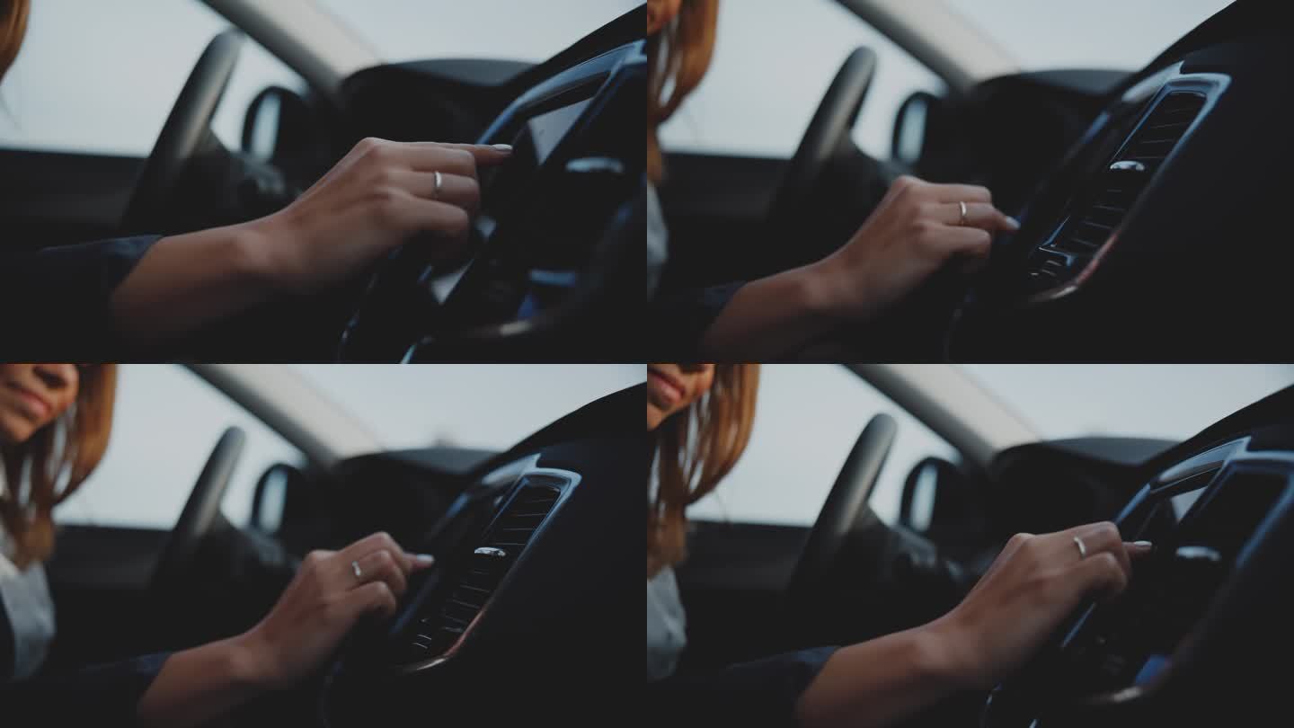 近距离的妇女使用触摸屏仪表盘在停放的汽车