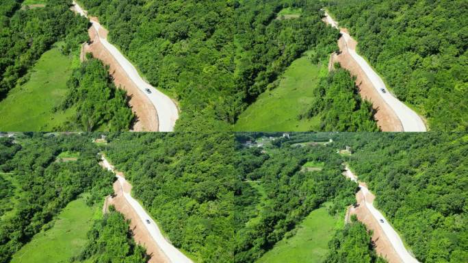无人机俯拍车辆行驶在森林道路