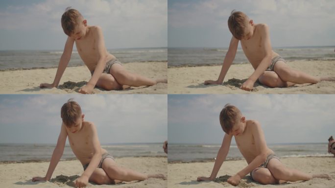 男孩在沙滩上玩沙子