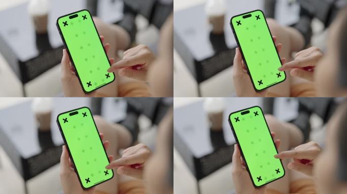 女子使用绿屏智能手机