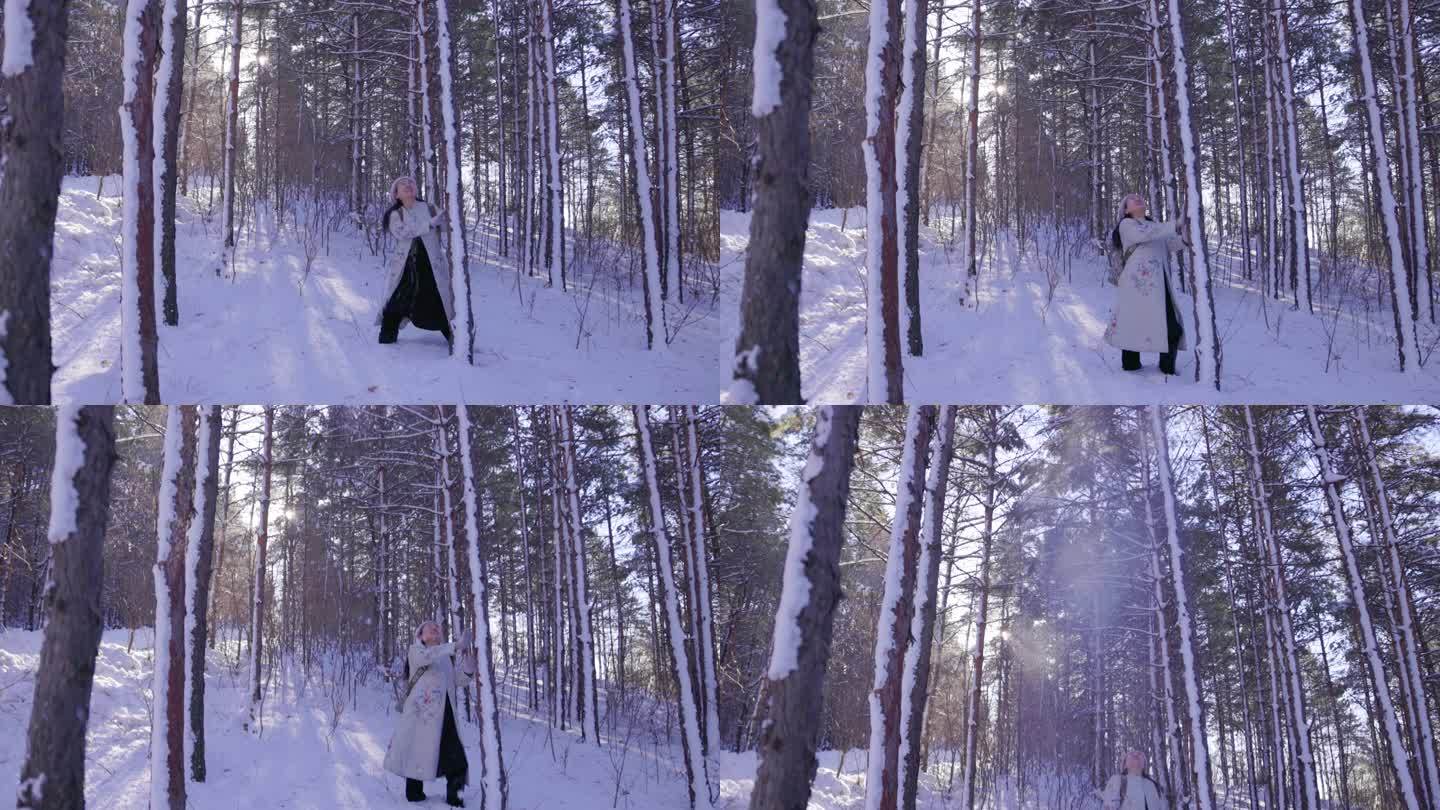 冬季户外雪中树林里的女性