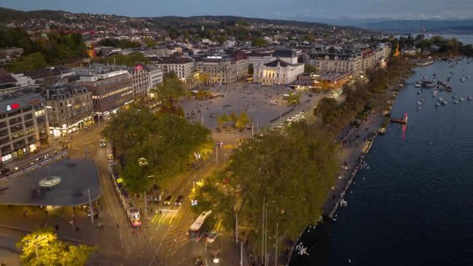 日落时分照亮苏黎世市中心著名的歌剧院交通广场湖滨航拍全景延时4k瑞士