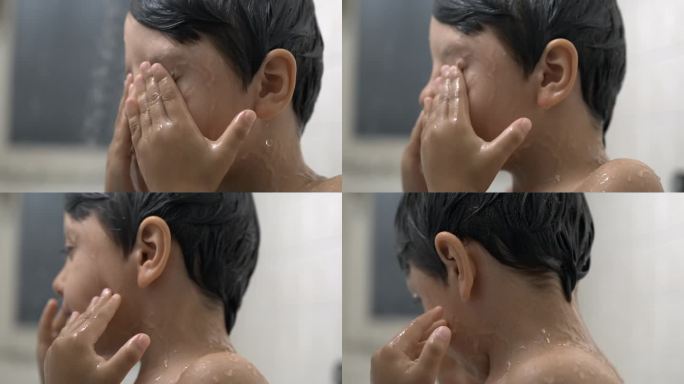 孩子在洗澡时揉眼睛的超级慢动作，特写孩子的脸从眼睛上取下肥皂