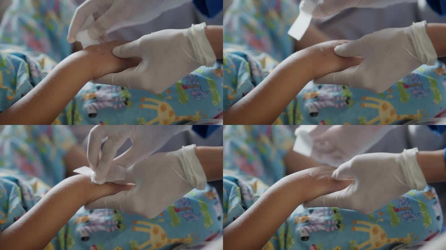 医院里，护士在照顾用布包着的孩子们的手。