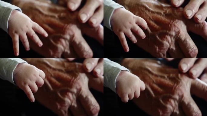 小男孩和爷爷布满皱纹的手的特写。手臂上的静脉。